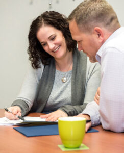 Anne Charette, Senior Executive Search Consultant helps a prospective candidate with his resume